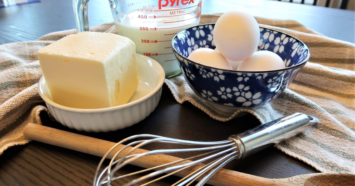 room-temperature butter and eggs beside a bowl of cake batter