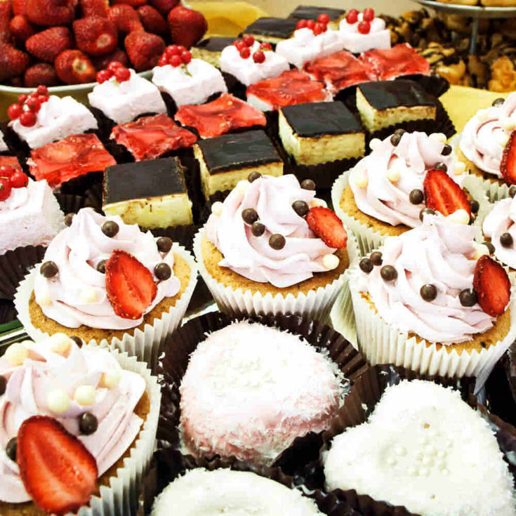 a tray of assorted baked goods on a set dining table